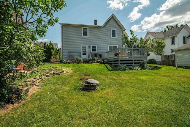 1915 7th St, Monroe, WI 53566 - back of property with a fire pit, a wooden deck, and a chimney