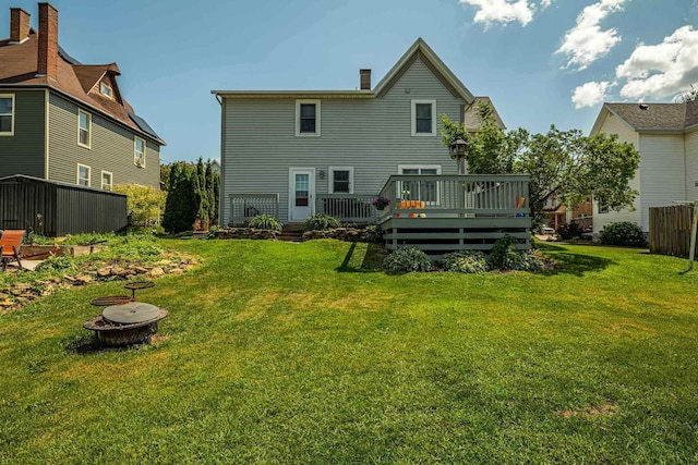 1915 7th St, Monroe, WI 53566 - rear view of property featuring a fire pit, a wooden deck, a yard, and a chimney