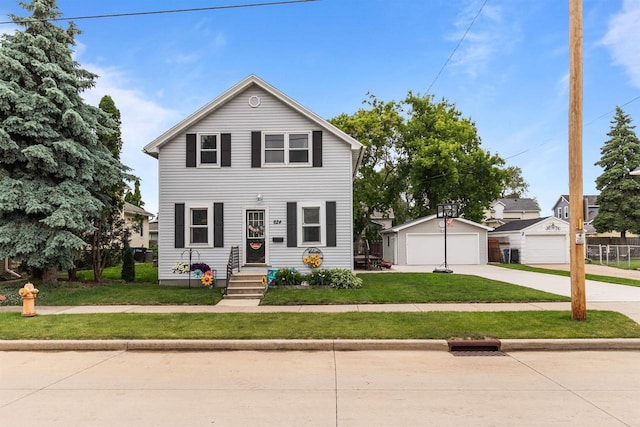 624 W 8th Ave, Oshkosh, WI 54902 - view of front of house with a front lawn, a garage, and an outdoor structure