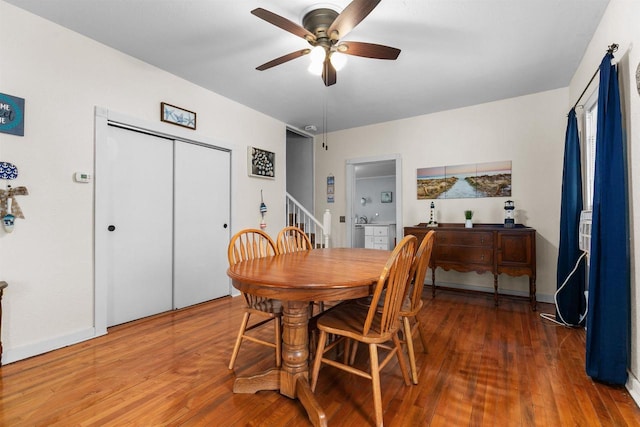 624 W 8th Ave, Oshkosh, WI 54902 - dining area with ceiling fan, wood finished floors, and stairway