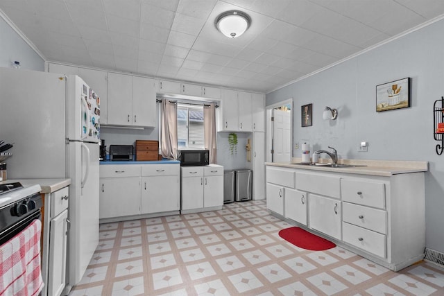 624 W 8th Ave, Oshkosh, WI 54902 - kitchen with light flooring, crown molding, black microwave, white cabinets, and stove