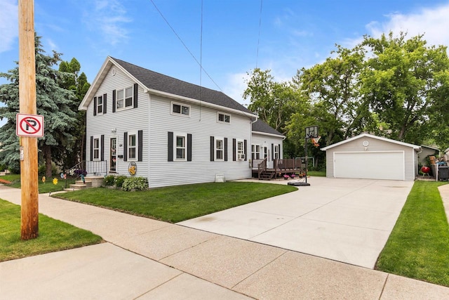 624 W 8th Ave, Oshkosh, WI 54902 - colonial house with an outdoor structure, a detached garage, a wooden deck, and a front yard