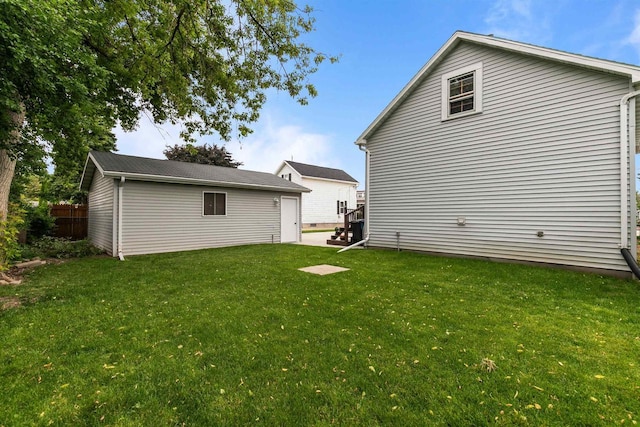624 W 8th Ave, Oshkosh, WI 54902 - rear view of house featuring a lawn and an outdoor structure