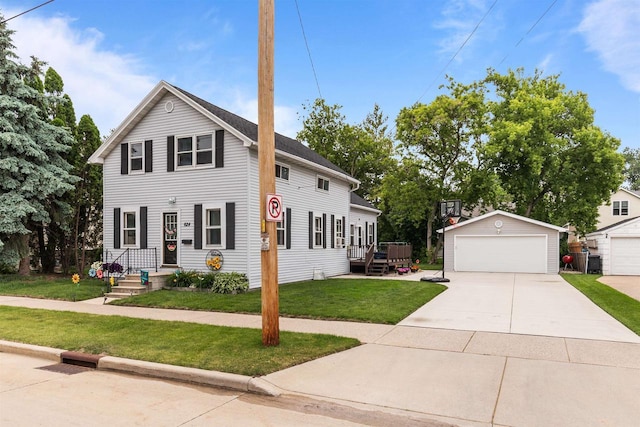 624 W 8th Ave, Oshkosh, WI 54902 - view of front of house featuring an outbuilding, a detached garage, and a front yard