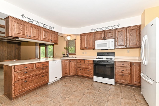 7701 W Coventry Dr, Franklin, WI 53132 - kitchen with white appliances, track lighting, brown cabinetry, and light countertops