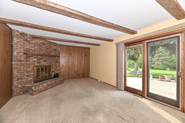 7701 W Coventry Dr, Franklin, WI 53132 - unfurnished living room with wooden walls, carpet floors, beam ceiling, and a fireplace