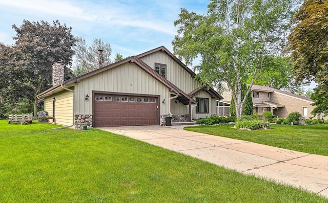7701 W Coventry Dr, Franklin, WI 53132 - view of front facade with a chimney, stone siding, a front lawn, a garage, and concrete driveway