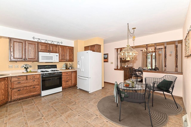 7701 W Coventry Dr, Franklin, WI 53132 - kitchen with white appliances, a chandelier, light countertops, decorative light fixtures, and brown cabinets