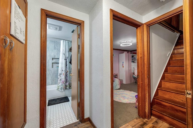 W8894 Cloverleaf Lake Rd, Clintonville, WI 54929 - hall featuring wood finished floors, stairs, and a textured wall