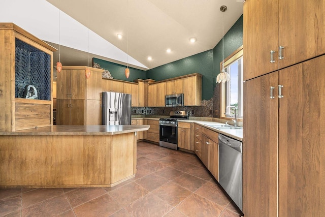 1022 Cortland Ln, Stevens Point, WI 54482 - kitchen with stainless steel appliances, a peninsula, light countertops, decorative backsplash, and hanging light fixtures