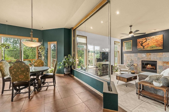 1022 Cortland Ln, Stevens Point, WI 54482 - tiled dining area featuring a tile fireplace and a ceiling fan