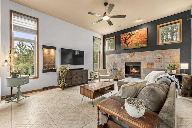1022 Cortland Ln, Stevens Point, WI 54482 - living room with healthy amount of natural light, a tiled fireplace, and a ceiling fan