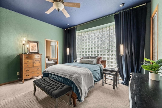 1022 Cortland Ln, Stevens Point, WI 54482 - carpeted bedroom featuring a textured wall, ceiling fan, and connected bathroom
