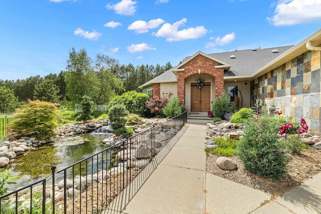 1022 Cortland Ln, Stevens Point, WI 54482 - property entrance with brick siding and roof with shingles