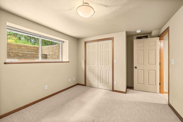 1022 Cortland Ln, Stevens Point, WI 54482 - unfurnished bedroom with a closet, light colored carpet, and a textured ceiling