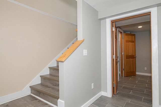 604 Wilson St, Winona, MN 55987 - stairway with baseboards and wood finished floors