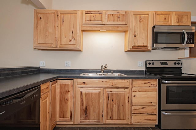 604 Wilson St, Winona, MN 55987 - kitchen with stainless steel appliances, dark countertops, and light brown cabinets