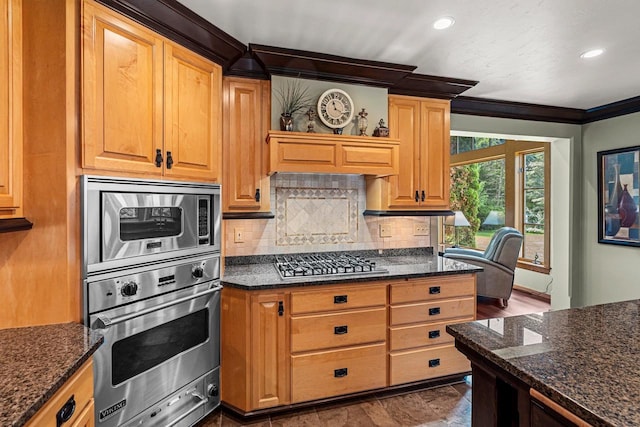 260 S Clay St, De Pere, WI 54115 - kitchen featuring appliances with stainless steel finishes, crown molding, backsplash, dark stone countertops, and recessed lighting