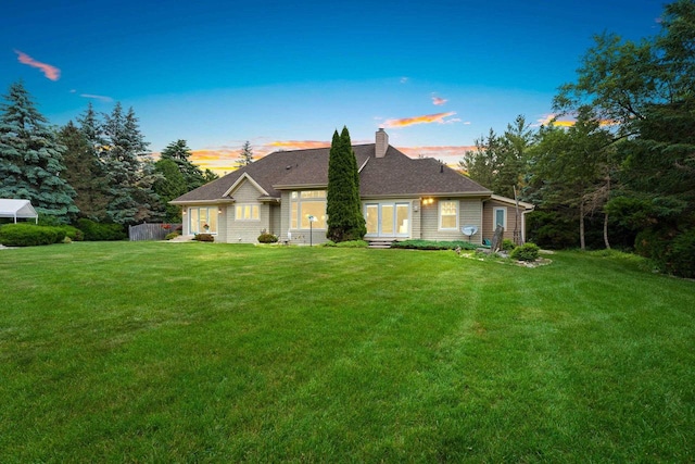 260 S Clay St, De Pere, WI 54115 - view of front of home with a chimney and a front lawn