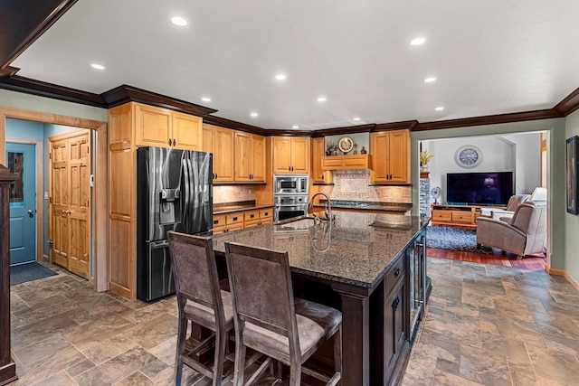 260 S Clay St, De Pere, WI 54115 - kitchen with stainless steel appliances, crown molding, decorative backsplash, stone tile floors, and dark stone counters