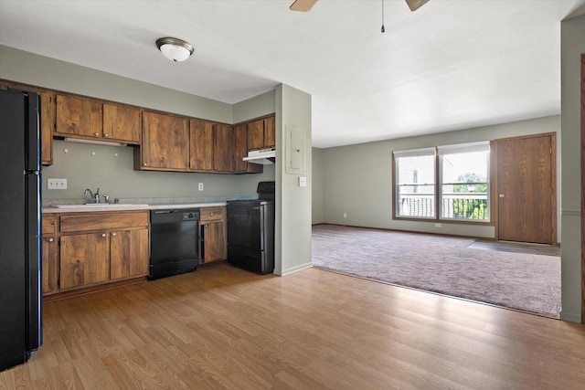 N114W16680 Crown Dr Unit 7, Germantown, WI 53022 - kitchen featuring black appliances, light countertops, light wood-style flooring, open floor plan, and a ceiling fan