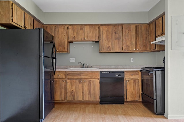 N114W16680 Crown Dr Unit 7, Germantown, WI 53022 - kitchen with black appliances, under cabinet range hood, light wood-type flooring, and light countertops