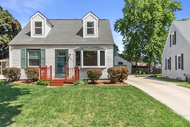 4502 W Sumac Pl, Milwaukee, WI 53219 - cape cod house with roof with shingles, a front lawn, an outdoor structure, and a detached garage