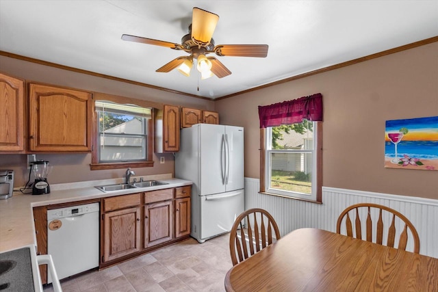 4502 W Sumac Pl, Milwaukee, WI 53219 - kitchen with white appliances, brown cabinets, a wainscoted wall, light countertops, and ceiling fan