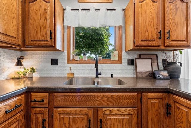4814 Placid Way, New Franken, WI 54229 - kitchen featuring brown cabinetry, dark countertops, and tasteful backsplash