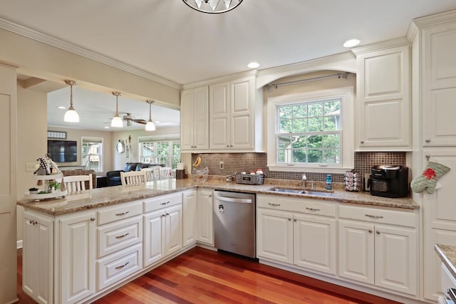 511 Wisconsin River Dr, Port Edwards, WI 54469 - kitchen featuring stainless steel dishwasher, a peninsula, backsplash, healthy amount of natural light, and crown molding