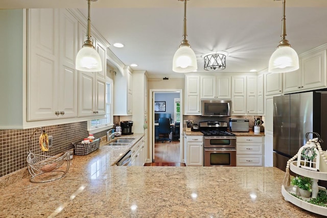 511 Wisconsin River Dr, Port Edwards, WI 54469 - kitchen featuring stainless steel appliances, light stone counters, backsplash, ornamental molding, and recessed lighting