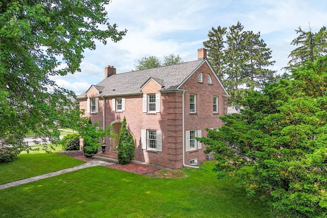 511 Wisconsin River Dr, Port Edwards, WI 54469 - view of front of house with a chimney, a front lawn, and brick siding