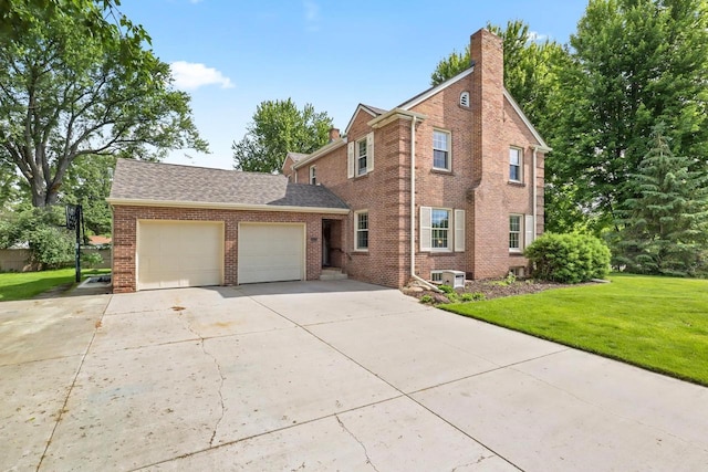 511 Wisconsin River Dr, Port Edwards, WI 54469 - view of front facade featuring brick siding, an attached garage, a front lawn, concrete driveway, and a shingled roof