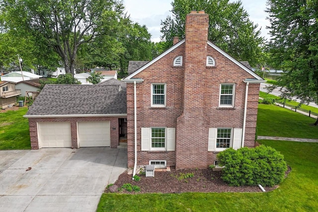 511 Wisconsin River Dr, Port Edwards, WI 54469 - view of front facade with a chimney, a garage, concrete driveway, and brick siding