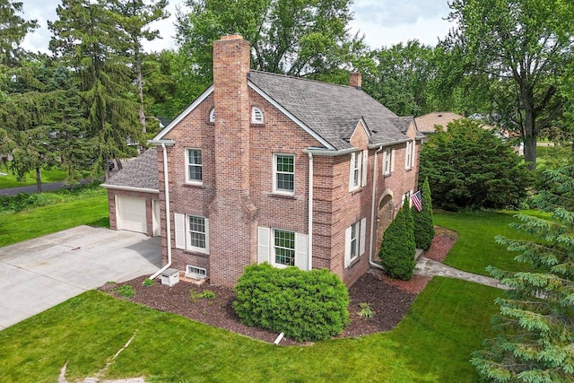 511 Wisconsin River Dr, Port Edwards, WI 54469 - view of home's exterior featuring a chimney, driveway, an attached garage, and a lawn