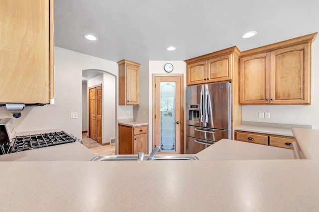 665 Black Earth Dr, De Pere, WI 54115 - kitchen featuring appliances with stainless steel finishes, arched walkways, light countertops, and recessed lighting