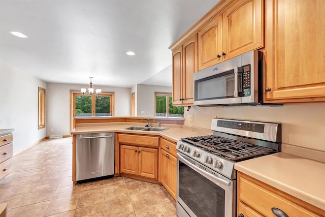 665 Black Earth Dr, De Pere, WI 54115 - kitchen with stainless steel appliances, a chandelier, a peninsula, light countertops, and recessed lighting