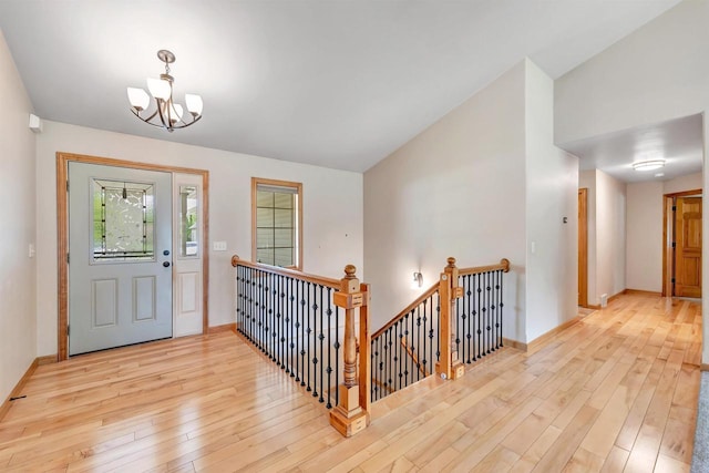 665 Black Earth Dr, De Pere, WI 54115 - foyer entrance featuring wood-type flooring, a chandelier, and vaulted ceiling