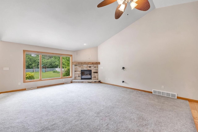 665 Black Earth Dr, De Pere, WI 54115 - unfurnished living room featuring lofted ceiling, ceiling fan, a fireplace, and light colored carpet