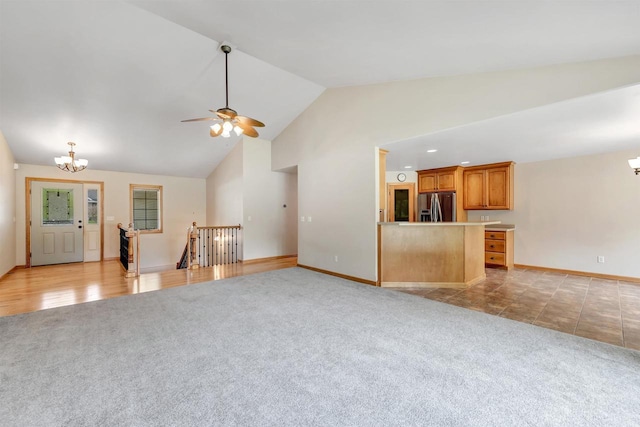 665 Black Earth Dr, De Pere, WI 54115 - unfurnished living room featuring a chandelier, light colored carpet, a ceiling fan, and high vaulted ceiling