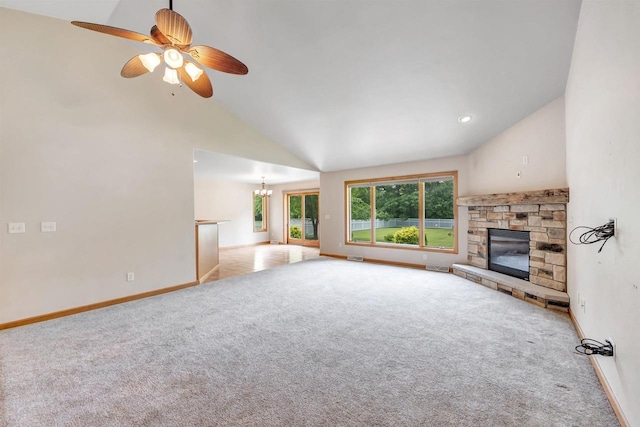 665 Black Earth Dr, De Pere, WI 54115 - unfurnished living room featuring a stone fireplace, carpet floors, vaulted ceiling, a chandelier, and a ceiling fan