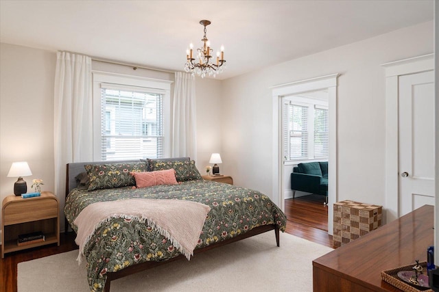 225 8th St, South Street, La Crosse, WI 54601 - bedroom featuring wood finished floors, multiple windows, and a chandelier