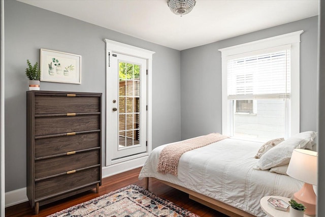 225 8th St, South Street, La Crosse, WI 54601 - bedroom with access to outside and dark wood-style floors