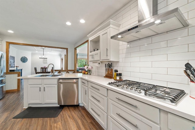 3287 E Old Highway 105, Superior, WI 54880 - kitchen featuring stainless steel appliances, wall chimney exhaust hood, a peninsula, backsplash, and light countertops