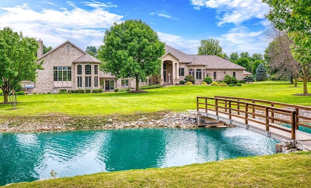 W1977 Center Valley Rd, Kaukauna, WI 54130 - back of property with a water view, a yard, a chimney, and stone siding