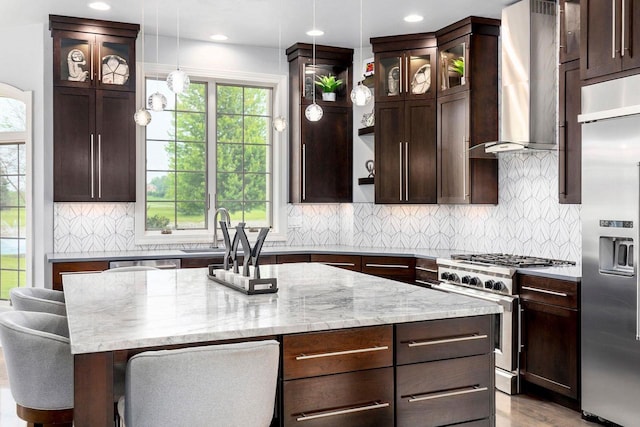 W1977 Center Valley Rd, Kaukauna, WI 54130 - kitchen featuring high end appliances, wall chimney range hood, dark brown cabinetry, pendant lighting, and recessed lighting