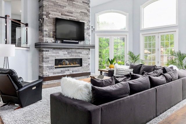 W1977 Center Valley Rd, Kaukauna, WI 54130 - living room with wood finished floors, a stone fireplace, healthy amount of natural light, and a towering ceiling