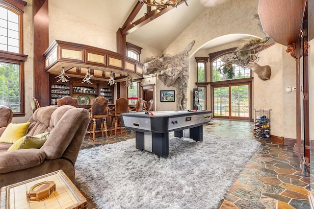 W1977 Center Valley Rd, Kaukauna, WI 54130 - game room featuring high vaulted ceiling, arched walkways, and stone finish floors