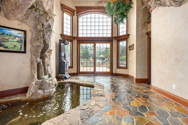 W1977 Center Valley Rd, Kaukauna, WI 54130 - living room with plenty of natural light, stone flooring, and a towering ceiling