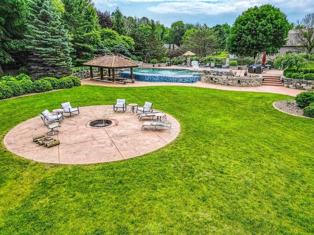W1977 Center Valley Rd, Kaukauna, WI 54130 - view of green lawn with a gazebo, a fire pit, a patio area, and an outdoor pool